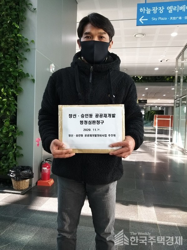 강대선 창신 공공재개발 추진위원회 공동대표가 행정심판을 접수하고 있다. [사진=창신 공공재개발 추진위원회 제공]