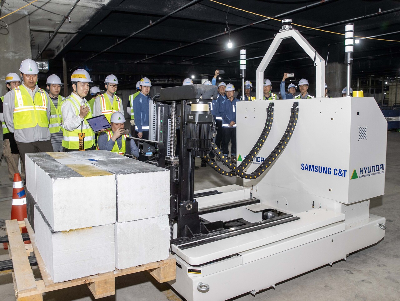 현대건설과 삼성물산이 공동 개발한 '스마트 자재 운반 로봇'이 현장에서 자재를 싣고 자율주행 이동하고 있다.  [사진=현대건설 제공]